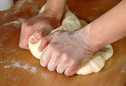 Man hands kneading dough